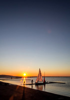 Red Sail Blue Sky at Sunset
